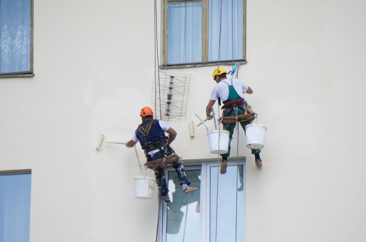 Rope access painter working on an Auckland building facade